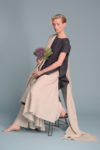 Neutral-colored linen scarf styled as a summer shawl wrap