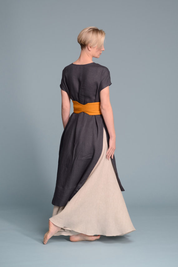 Back view of the tied linen obi belt MARU in turmeric on a model
