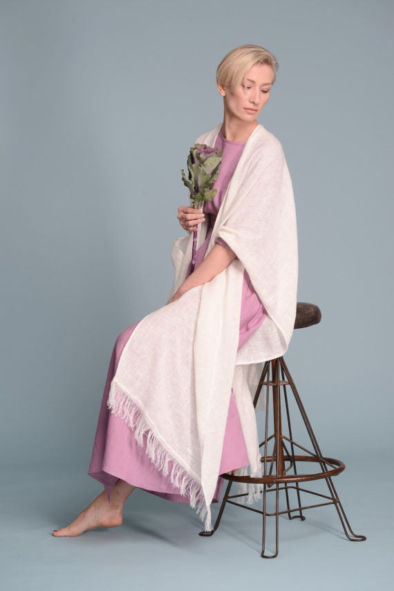 Side profile of the Open-Weave Linen Cape in Natural Flax, emphasizing its wide silhouette