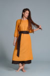Model in motion, showing the lightweight and breathable medium-weight linen fabric dress and adjastable tie belt.
