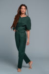 Model wearing slim-fit linen trousers paired with a linen blouse for an elegant look.