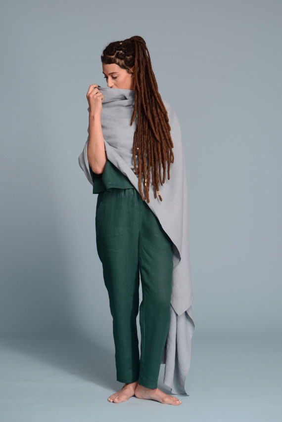 Linen wrap shawl in light teal color, draped over shoulders