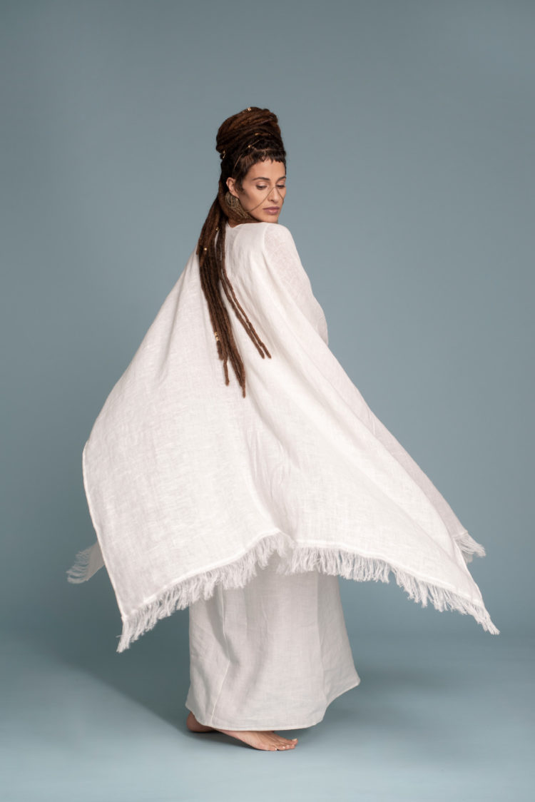 Model gracefully moving in the Open-Weave Linen Cape, demonstrating the flow of the fabric