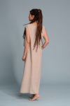 Model wearing a lightweight beige linen dress with a relaxed fit and airy fabric, ideal for summer days.