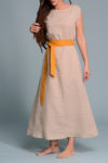 Close-up of the boat neckline and short sleeves of the beige linen dress.