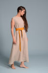Front view of the beige linen dress styled with a belt for a fitted look.