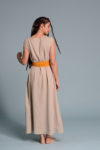 Back view of the lightweight beige linen dress highlighting its elegant simplicity.