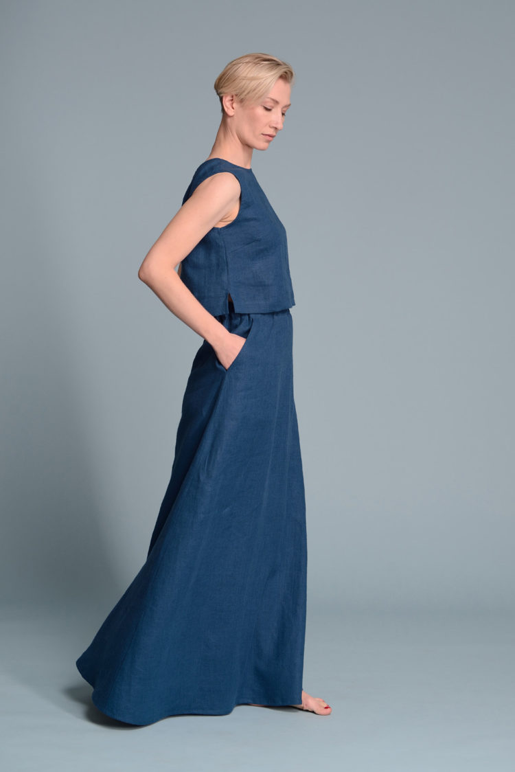 Side profile of the LUNA linen tank top highlighting its straight cut and small side slits