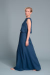 Model wearing the turquoise blue linen tank top styled with high-waisted skirt for a casual look.
