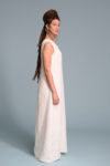 Side view of the sleeveless linen dress, showing its relaxed and flowy drape.