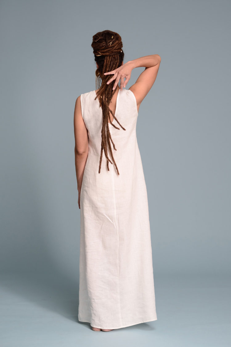 The maxi-length hemline, adding an elegant, elongated silhouette.