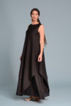 Model twirling in the EFRAT linen dress, showing the movement and flow of the double-layered construction