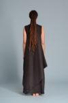 Side profile of the EFRAT dress, perfect as a special occasion dress, featuring an asymmetrical hem and sleeveless design