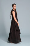 Side profile of the EFRAT dress, perfect as a special occasion dress, featuring an asymmetrical hem and sleeveless design