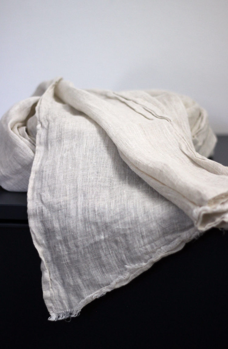 Natural linen SPF scarf, an airy and stylish way to stay protected from the sun.