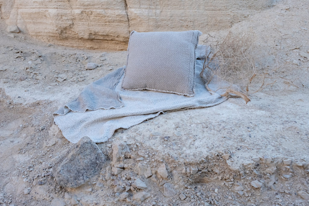 Linen throw blanket used as a picnic or beach cover outdoors