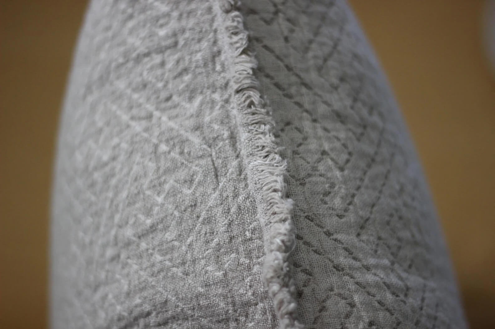 Double-sided linen cushion cover showing natural flax and ivory color contrast