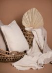 Double-sided linen throw blanket showing natural flax and ivory colors