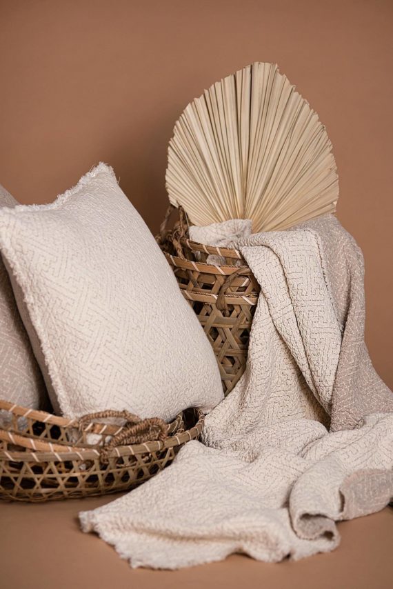 Double-sided linen throw blanket showing natural flax and ivory colors
