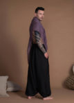 Side view of black linen harem pants, featuring deep pockets and an elastic waistband