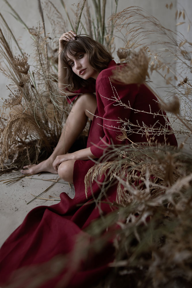 Women wears dark red outfit from Mistral Breath Linen Collection 2024, Sustainable Linen Clothes Online.
